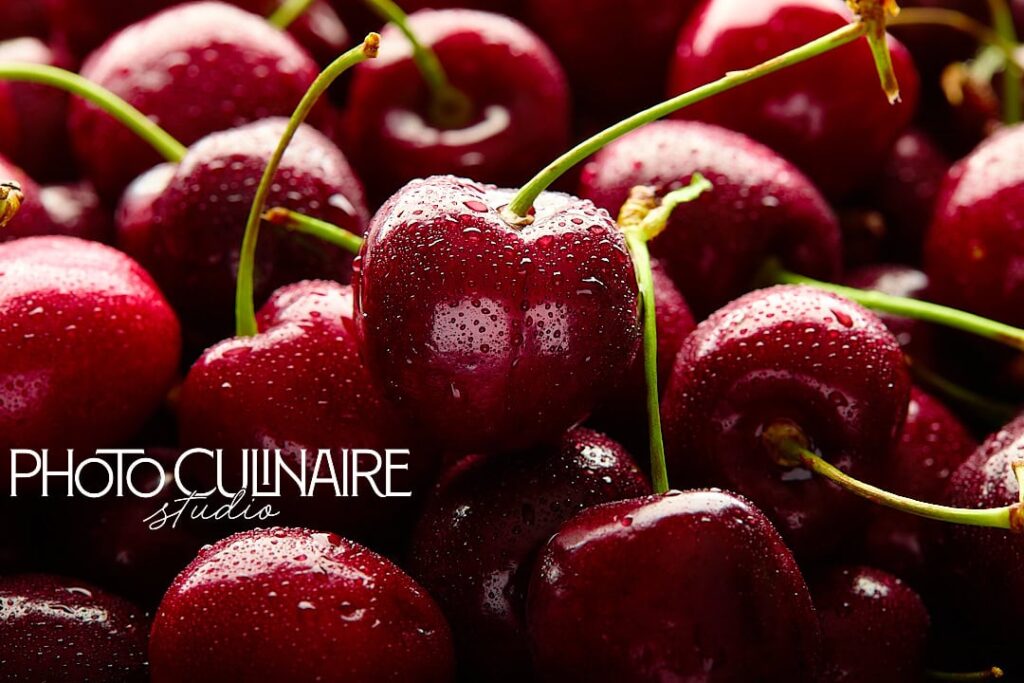 cherries sprinkled with water in backlighting 