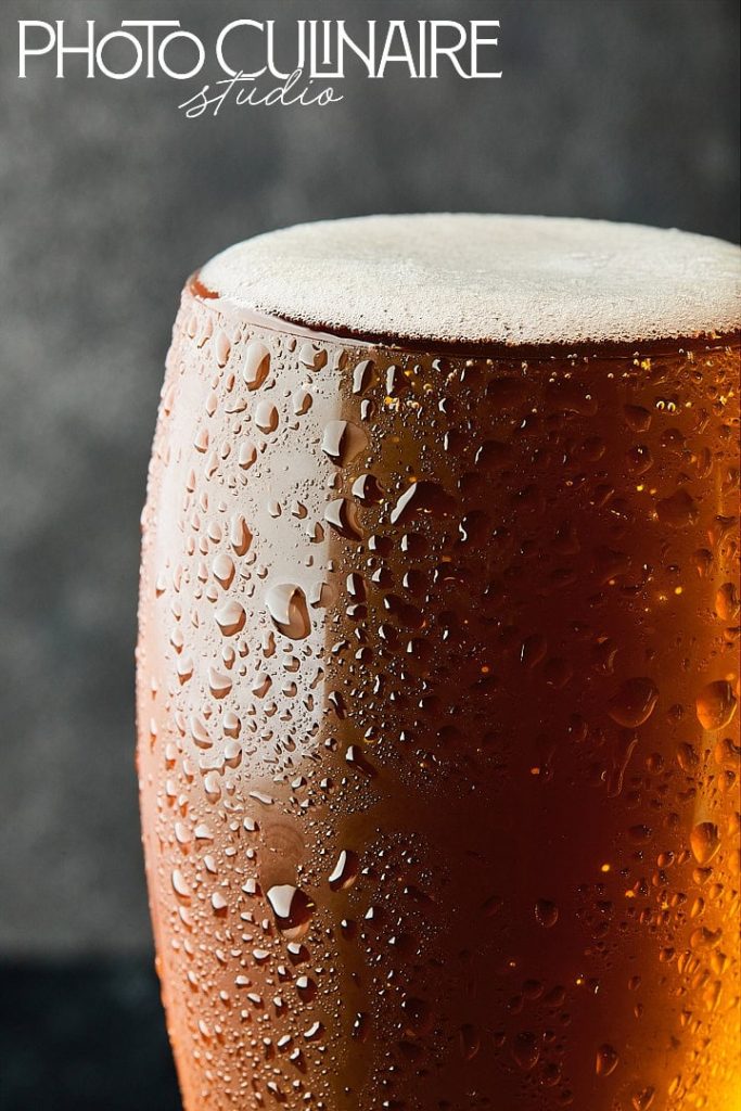glass of beer with side lighting highlighting texture in food photography 
