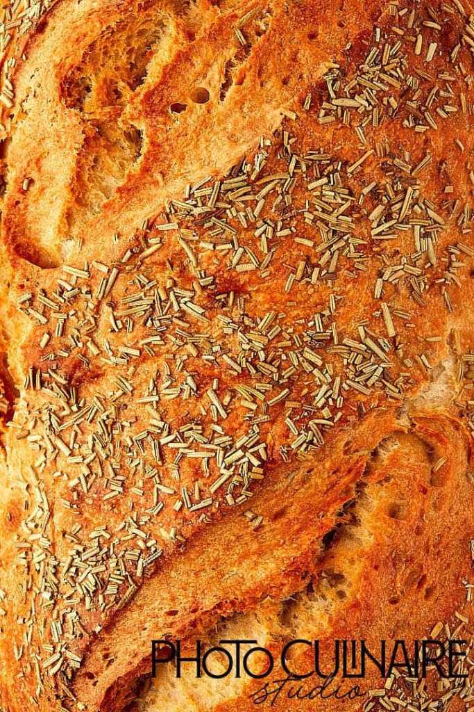 rosemary bread loaf in side lighting highlighting texture in food photography 