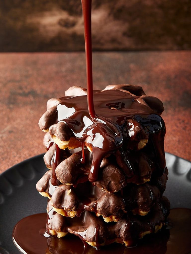 side lighting food photography waffles with chocolate syrup pour showing texture