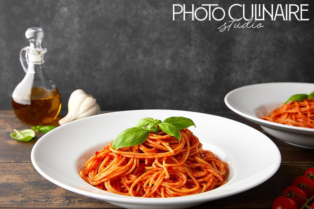 plate of spaghetti illuminated with side lighting creating shadows and texture in food photography 